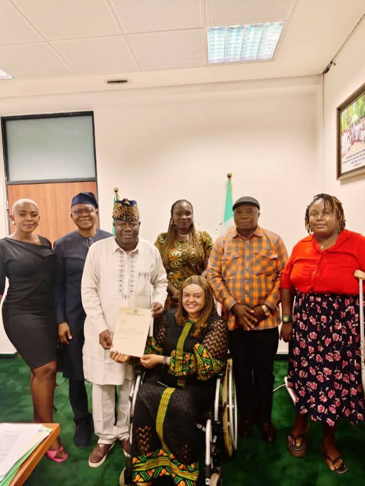 GDGI representatives, including a wheelchair user, with the Chairman of the House Committee on Disability Matters, who holds a signed letter of collaboration