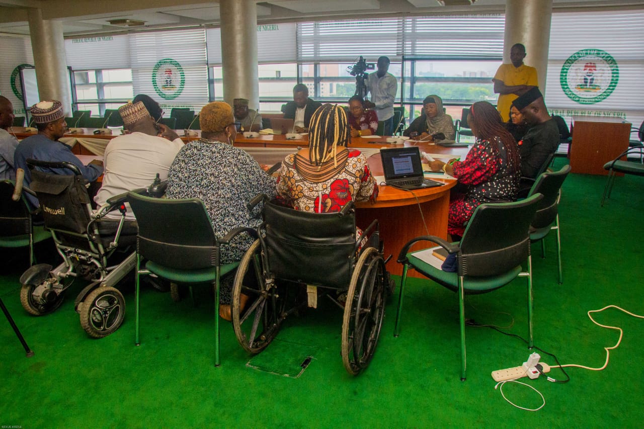 Stakeholders seated around the committee table, Committee Room 301