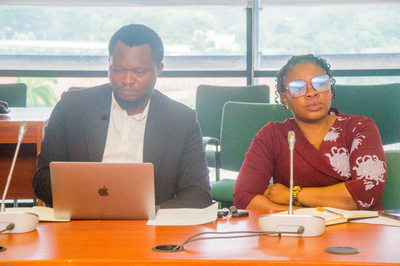 Delegates seated at the committee table with laptops and notes